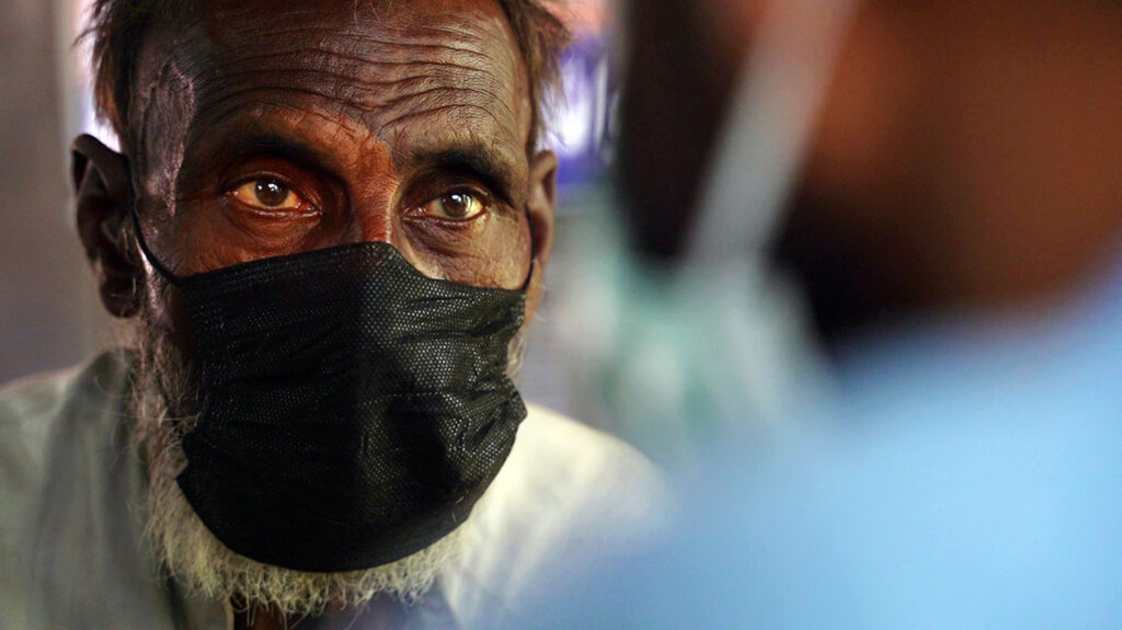 A man has his eyes checked.