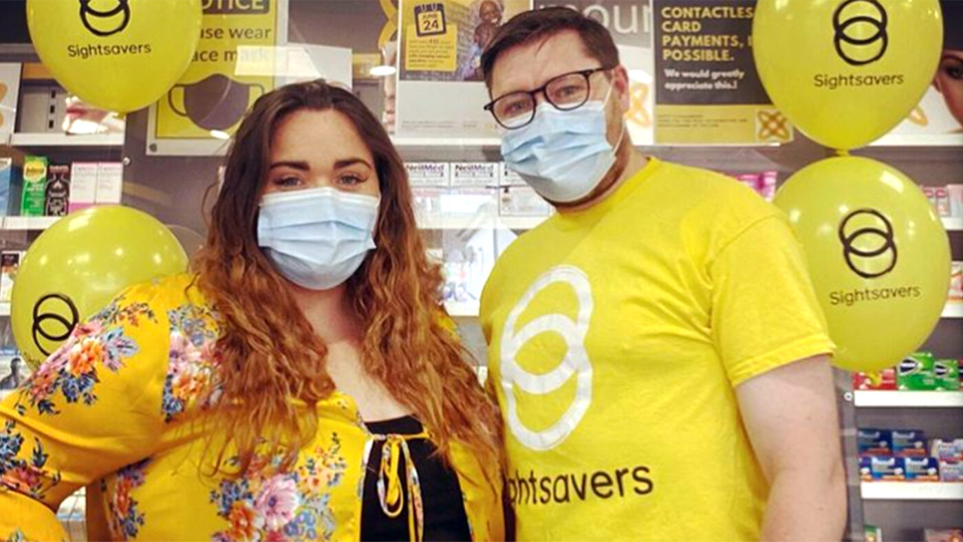 Two people wearing masks and yellow outfits.