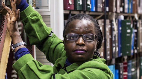 A women with visual impairment working in a library in Kenya.