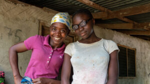Patience from Liberia wearing her new glasses, whilst standing next to her mother, betty.