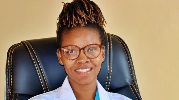 Dr Jalikatu smiles while wearing her surgical coat.