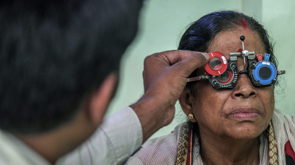 A middle aged woman gets her eyes tested.