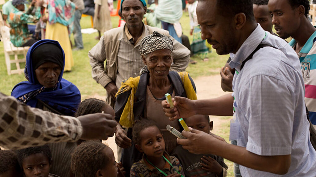 Epidemiologist Michael Dejene administers antibiotics for trachoma in a local community.