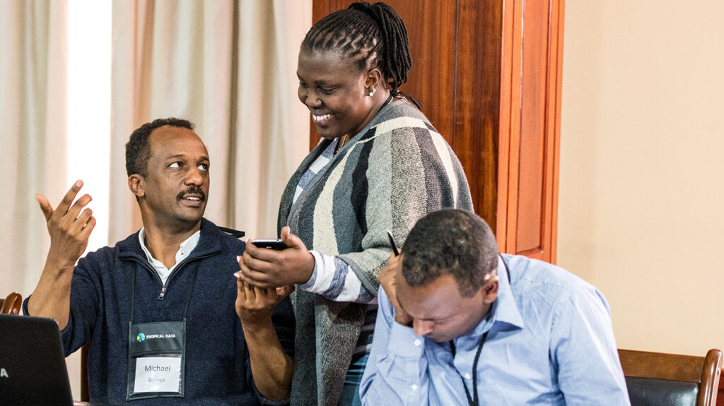 Epidemiologist Michael Dejene from Tropical Data talks to colleagues.