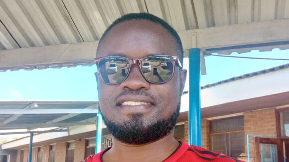 Alinafe smiles while wearing sunglasses.