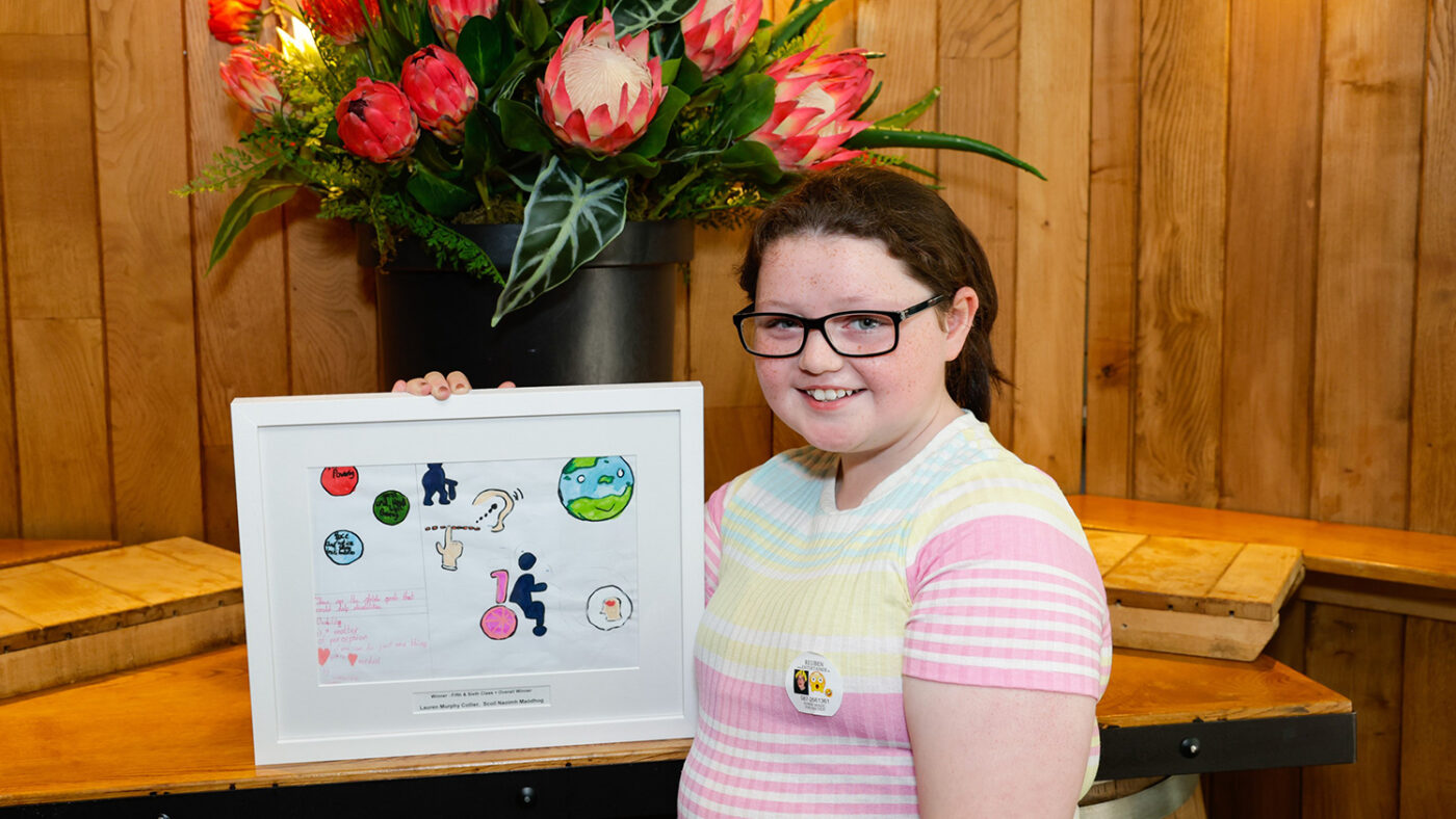 Junior Painter award-winner Lauren shows off her framed artwork.