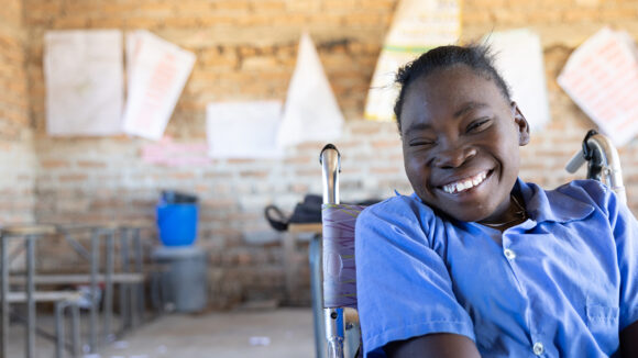 Grace, who uses a wheelchair, sits in her old primary school classroom.