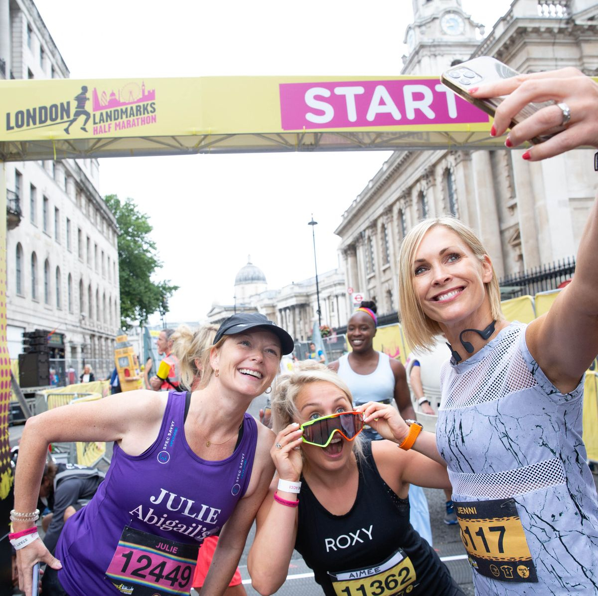 Three women take a selfie in front of the start sign at the London Landmarks Half Marathon.