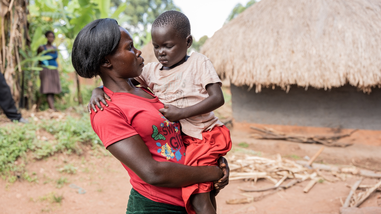 Fosca carries her daughter, Happy, who has her eyes closed.