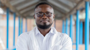 An eye health doctor wearing a smart white shirt and sunglasses.