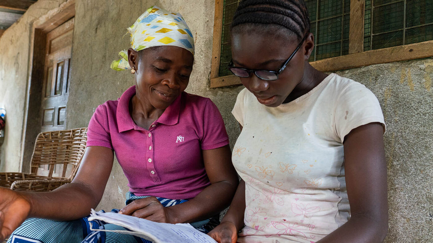 Betty reads to her mother using her new glasses.