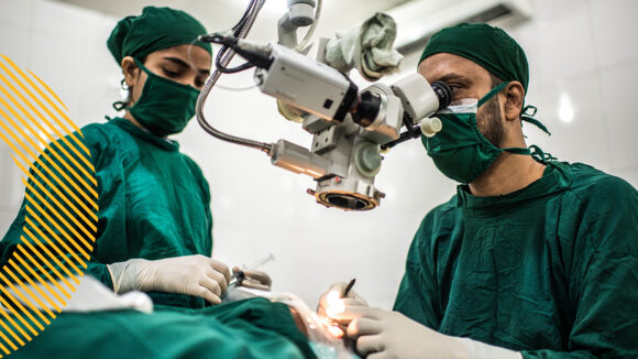 Two surgeons in an operating room perform a cataract operation.