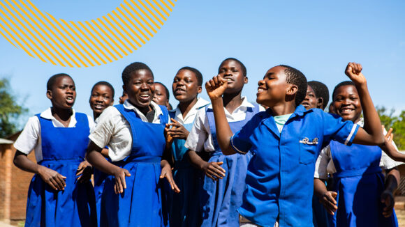 A group of students celebrating the elimination of trachoma in Malawi.