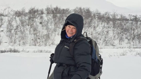Caitríona stands in a snowy Arctic landscape.
