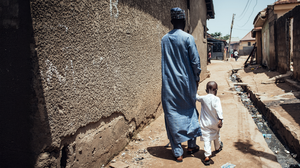 Muhammad and his father walking down a path outside.