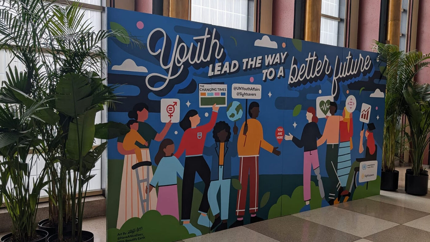 A mural with representations of young people with disabilities. The people are holding up campaign banners, and one of the female figures is holding a copy of The Changing Times newspaper. A banner across the mural reads 'Youth lead the way to a better future'.