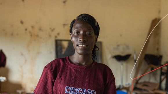 A woman stands in a knitting workshop.