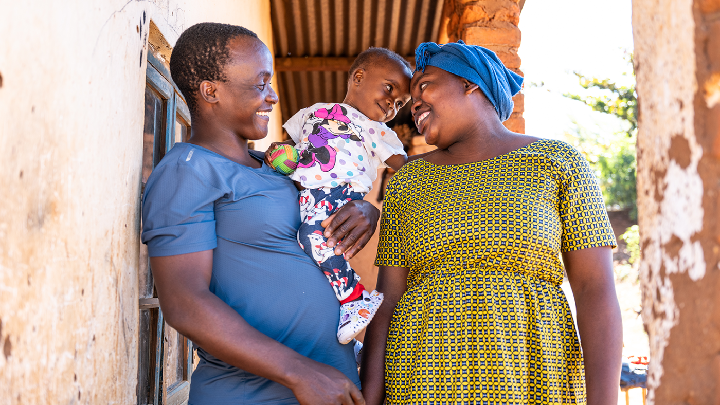 Shamim, two, is held by her father, Christopher, while standing with her mother, Loney.